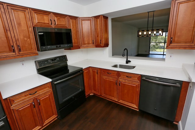 kitchen with dishwasher, a sink, light countertops, dark wood-style floors, and black range with electric cooktop