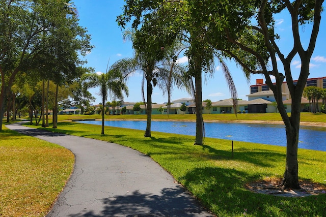 view of property's community featuring a yard, a water view, and a residential view