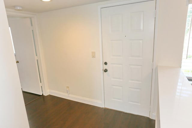 entrance foyer with baseboards and dark wood-style floors