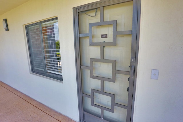 property entrance featuring stucco siding