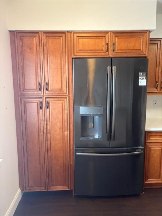 7290 Kinghurst Dr Unit 407, Delray Beach, FL 33446 - kitchen with fridge with ice dispenser, brown cabinets, dark wood-style flooring, and baseboards