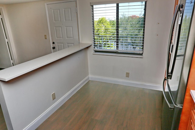 interior space with baseboards and dark wood finished floors