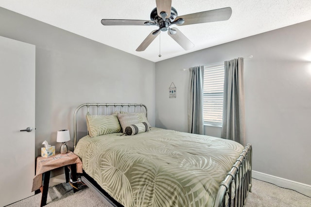 bedroom with light carpet, ceiling fan, and baseboards