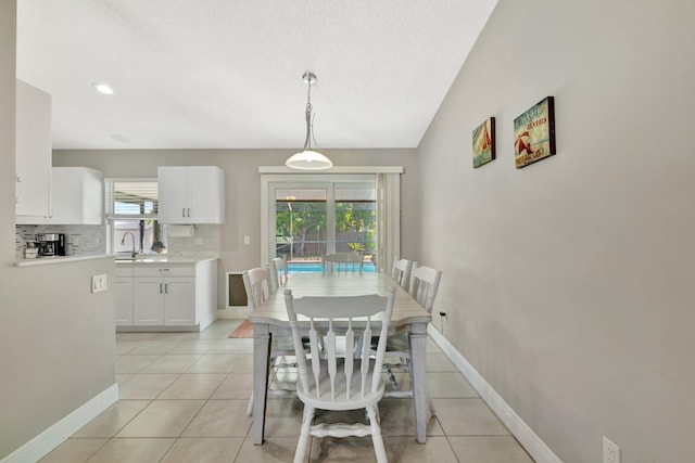 dining area featuring light tile patterned floors and baseboards