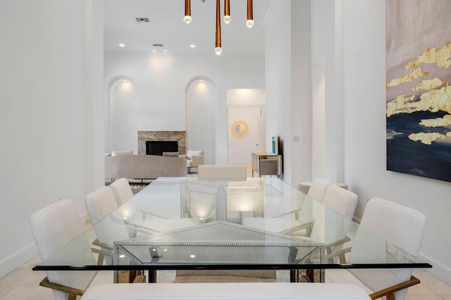 dining area with visible vents, baseboards, and a fireplace