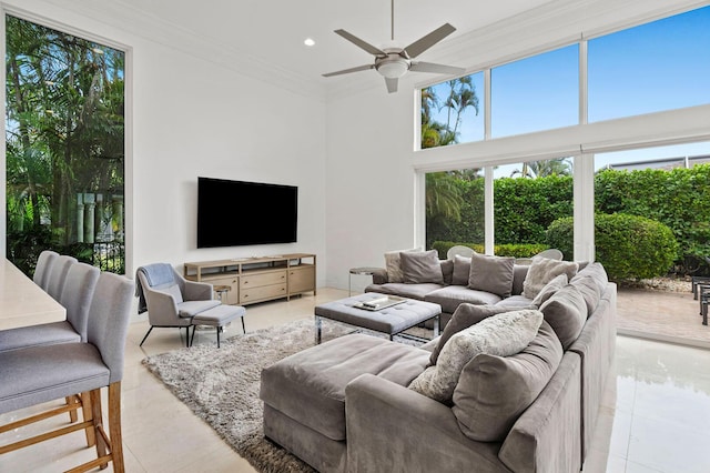living room featuring recessed lighting, a towering ceiling, a ceiling fan, and ornamental molding