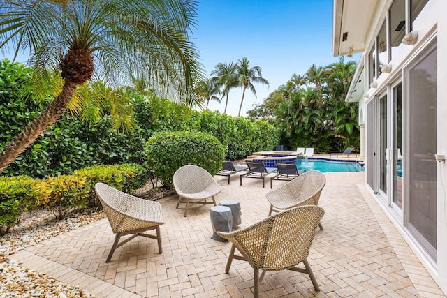 view of patio / terrace featuring a pool with connected hot tub