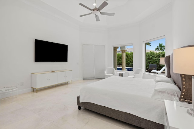 bedroom featuring a high ceiling, a ceiling fan, and baseboards