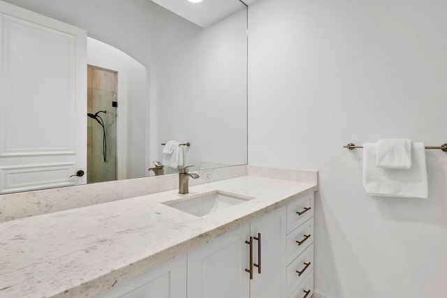 bathroom with vanity and a shower