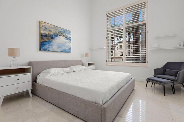 bedroom featuring baseboards and light tile patterned floors
