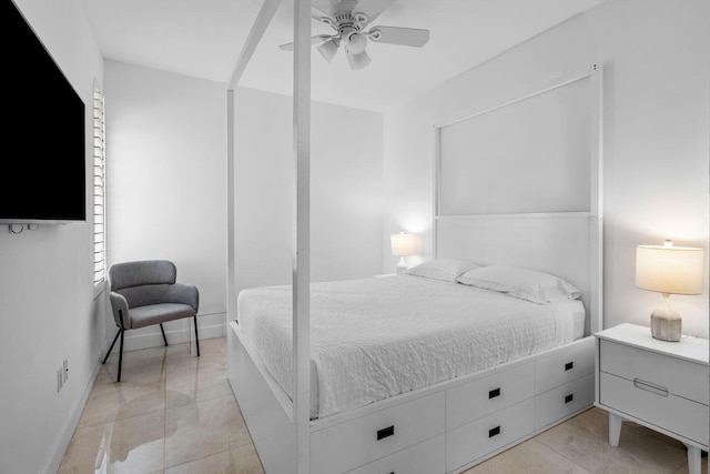 bedroom with a ceiling fan and baseboards