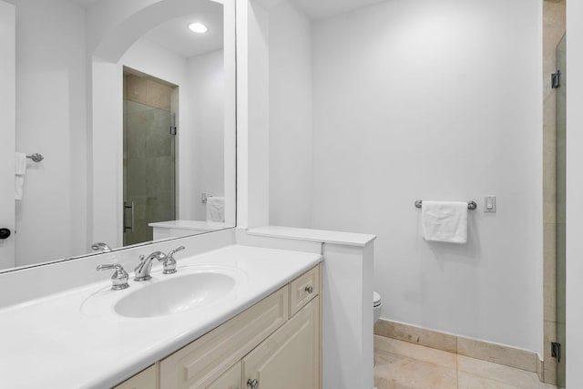 full bath with a shower stall, tile patterned floors, toilet, vanity, and baseboards