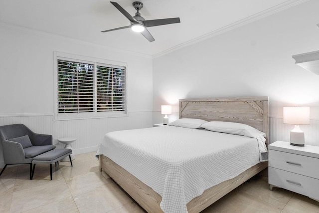 bedroom featuring crown molding, ceiling fan, and wainscoting