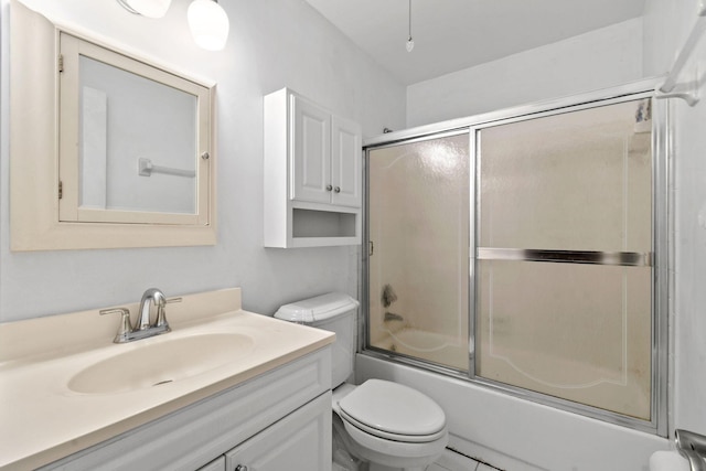 bathroom featuring toilet, vanity, and enclosed tub / shower combo