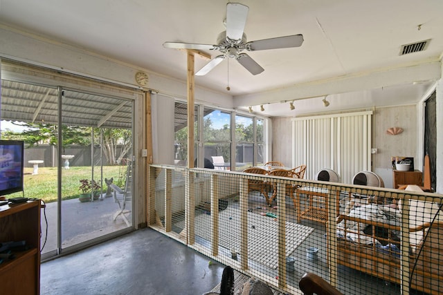 sunroom / solarium featuring a wealth of natural light, visible vents, and a ceiling fan