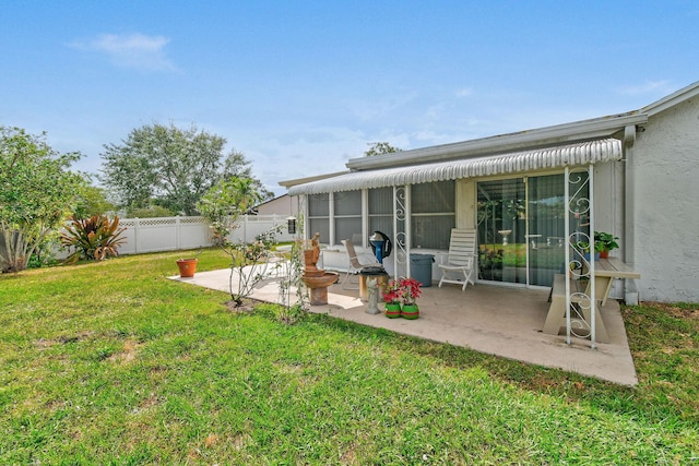 back of property with a patio area, stucco siding, fence, and a lawn