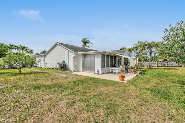 back of property featuring a yard, stucco siding, fence, central air condition unit, and a patio area