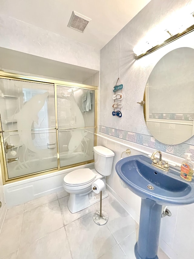 full bathroom with shower / bath combination with glass door, visible vents, and toilet