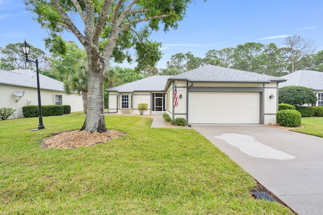 ranch-style house featuring concrete driveway, stucco siding, a front yard, a garage, and a shingled roof