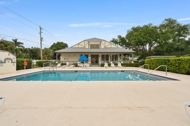 pool featuring fence and a patio