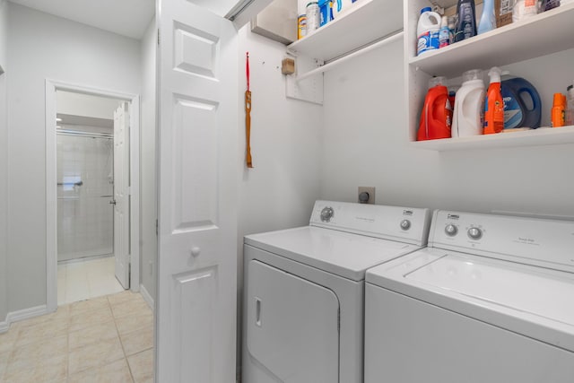 laundry area featuring light tile patterned floors, independent washer and dryer, and laundry area