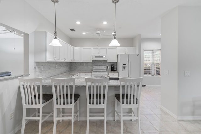 kitchen featuring exhaust hood, visible vents, ceiling fan, and white appliances