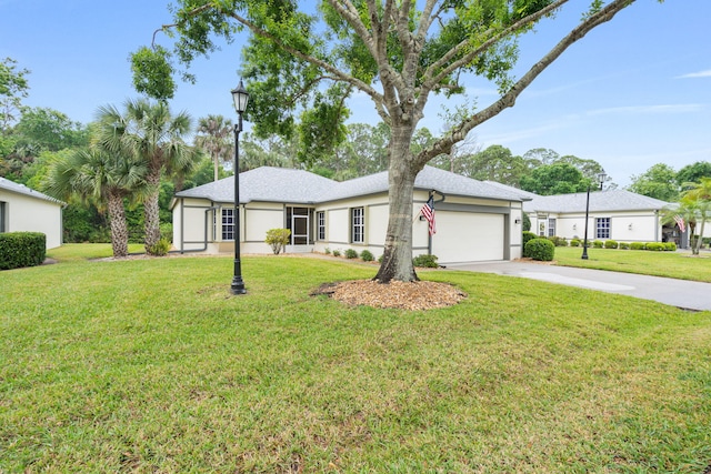 single story home featuring a garage, a front yard, driveway, and stucco siding
