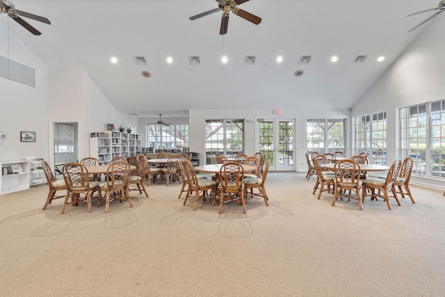 dining room featuring high vaulted ceiling, visible vents, light colored carpet, and a ceiling fan