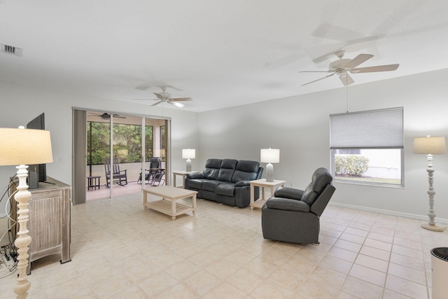 living area featuring visible vents and a ceiling fan