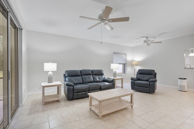 living room featuring light tile patterned floors, baseboards, and a ceiling fan