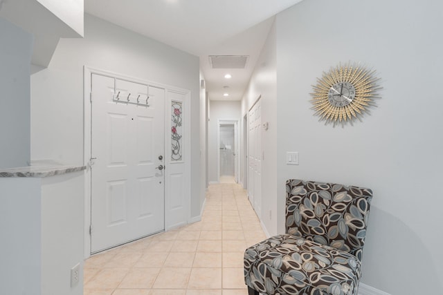 hall featuring recessed lighting, light tile patterned floors, and baseboards