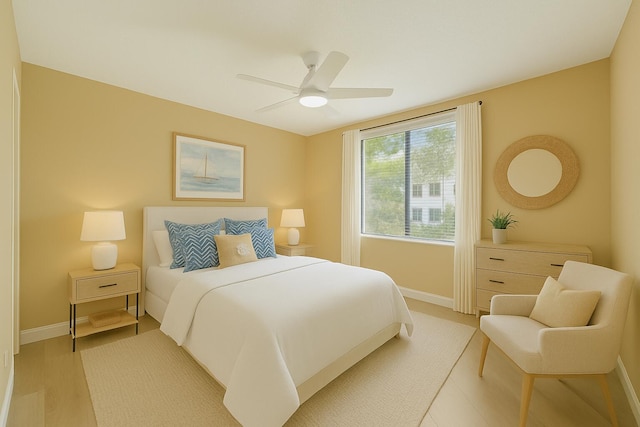 2880 NE 14th Street Cswy Unit 113, Pompano Beach, FL 33062 - bedroom featuring baseboards, light wood finished floors, and ceiling fan