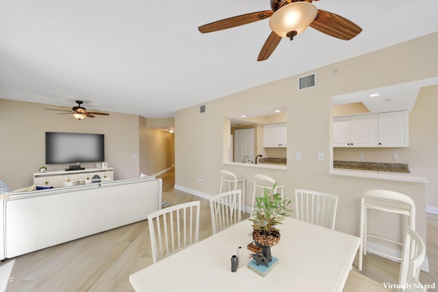 2880 NE 14th Street Cswy Unit 113, Pompano Beach, FL 33062 - dining space featuring a ceiling fan, light wood-style flooring, and baseboards