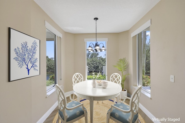 2880 NE 14th Street Cswy Unit 113, Pompano Beach, FL 33062 - dining space with a wealth of natural light, baseboards, and wood finished floors