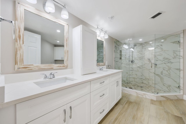 2880 NE 14th Street Cswy Unit 113, Pompano Beach, FL 33062 - bathroom featuring a marble finish shower, visible vents, double vanity, and a sink
