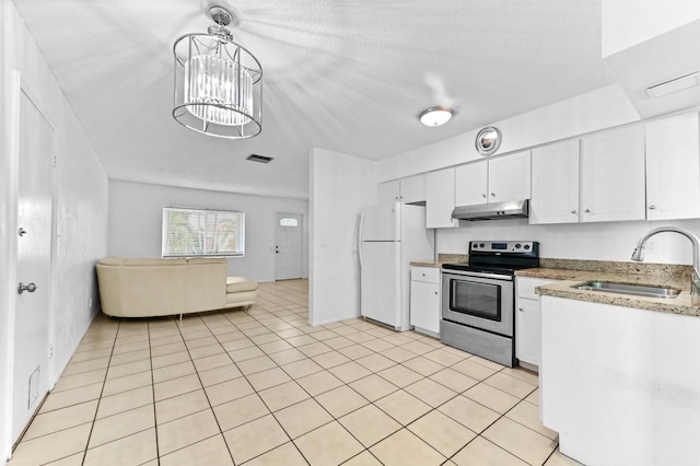 7000 NW 95th Ter, Tamarac, FL 33321 - kitchen with stainless steel range with electric cooktop, a sink, freestanding refrigerator, under cabinet range hood, and white cabinetry