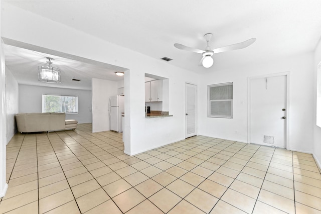 7000 NW 95th Ter, Tamarac, FL 33321 - unfurnished living room with a ceiling fan, visible vents, and light tile patterned floors
