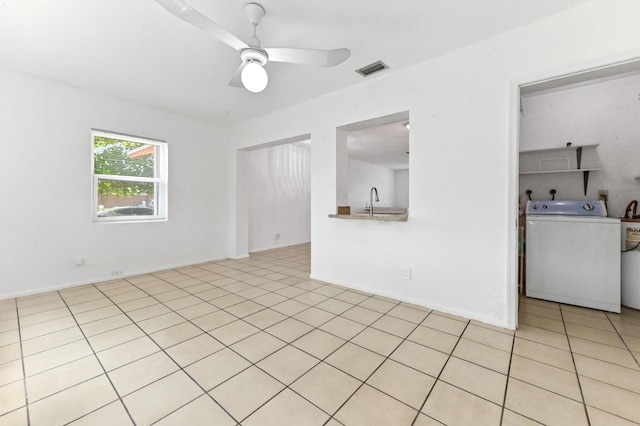 7000 NW 95th Ter, Tamarac, FL 33321 - unfurnished living room featuring a ceiling fan, washer / clothes dryer, visible vents, light tile patterned floors, and a sink