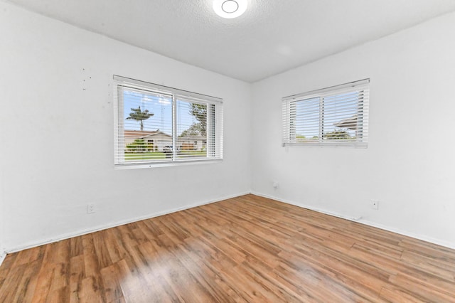 7000 NW 95th Ter, Tamarac, FL 33321 - unfurnished room with baseboards and wood finished floors