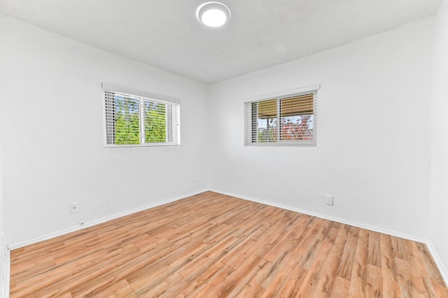 7000 NW 95th Ter, Tamarac, FL 33321 - empty room with baseboards and light wood-style flooring