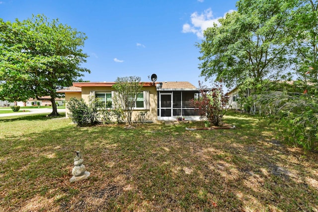 7000 NW 95th Ter, Tamarac, FL 33321 - back of house featuring a sunroom, stucco siding, and a yard