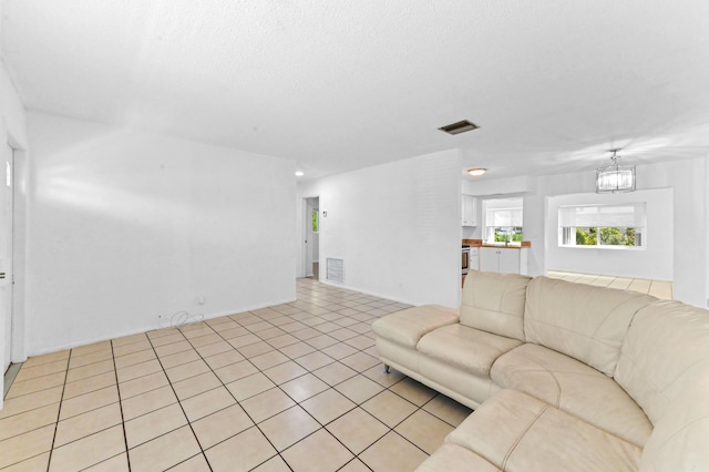 7000 NW 95th Ter, Tamarac, FL 33321 - living area with visible vents, light tile patterned flooring, and a notable chandelier