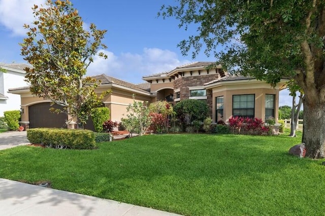 9600 Equus Cir, Boynton Beach, FL 33472 - view of front of home featuring a front lawn, a garage, stucco siding, stone siding, and driveway
