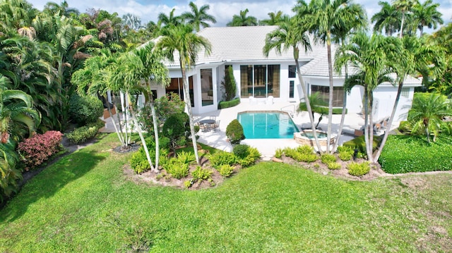 17652 Lake Estates Dr, Boca Raton, FL 33496 - rear view of property with stucco siding, a tile roof, a patio, a lawn, and a pool with connected hot tub