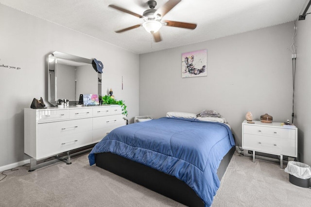 bedroom with light carpet, baseboards, and ceiling fan