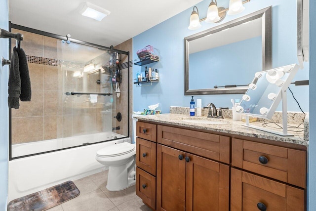 full bathroom with tile patterned floors, vanity, shower / bath combination with glass door, and toilet