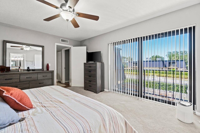 bedroom with carpet flooring, a ceiling fan, and visible vents