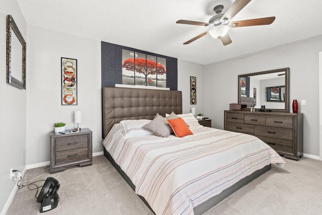 bedroom with baseboards, ceiling fan, and light colored carpet
