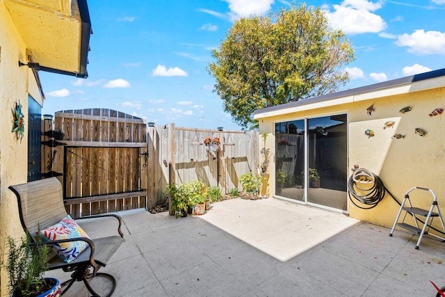 view of patio / terrace featuring fence and a gate