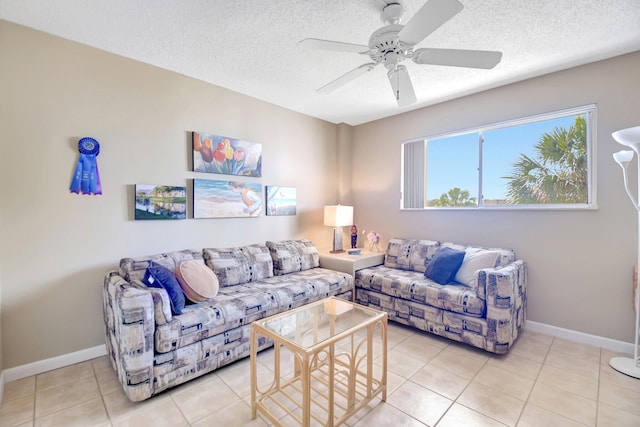 living room with light tile patterned flooring, a textured ceiling, and baseboards